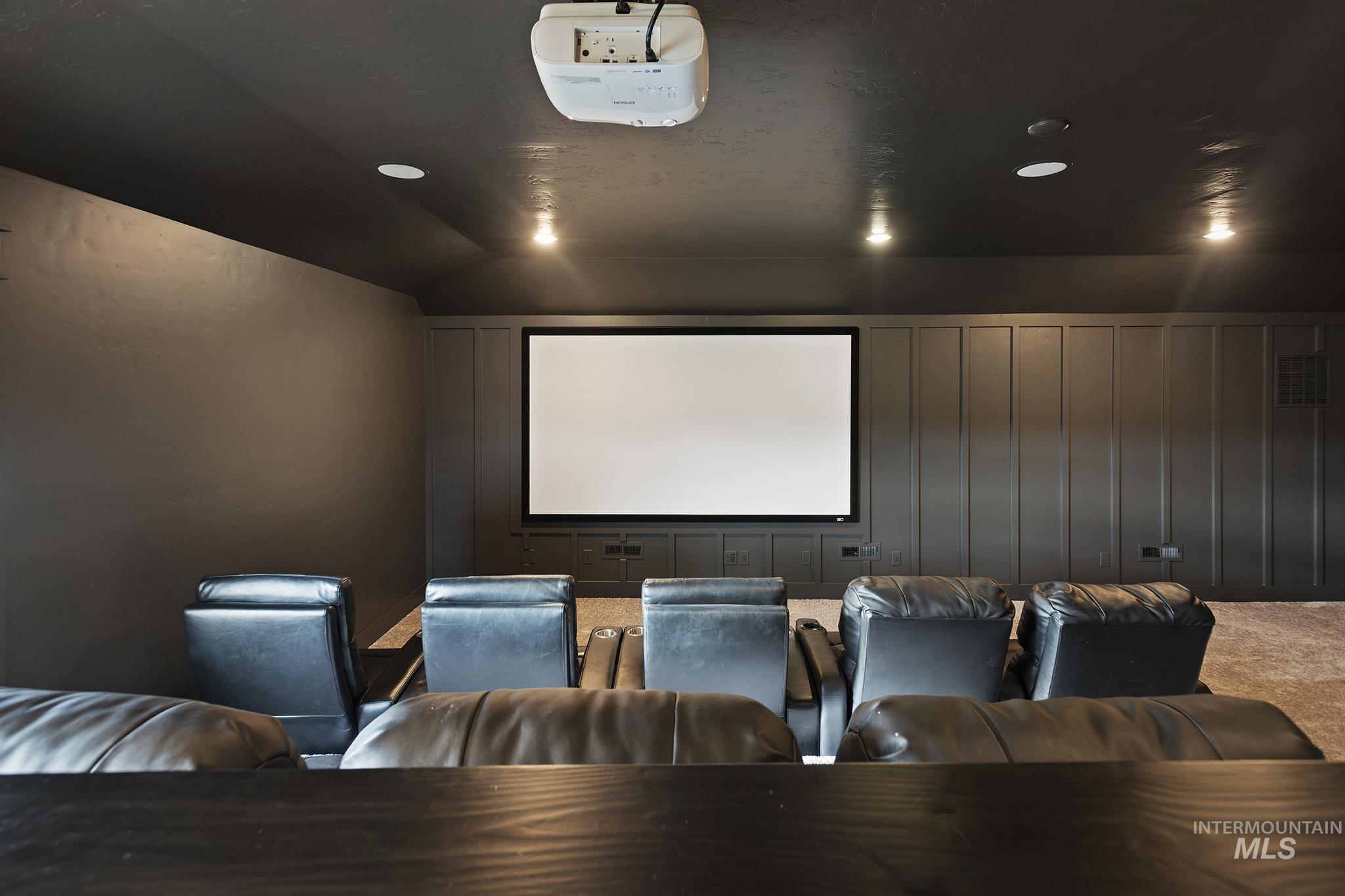 Cinema room featuring vaulted ceiling, carpet floors, and recessed lighting
