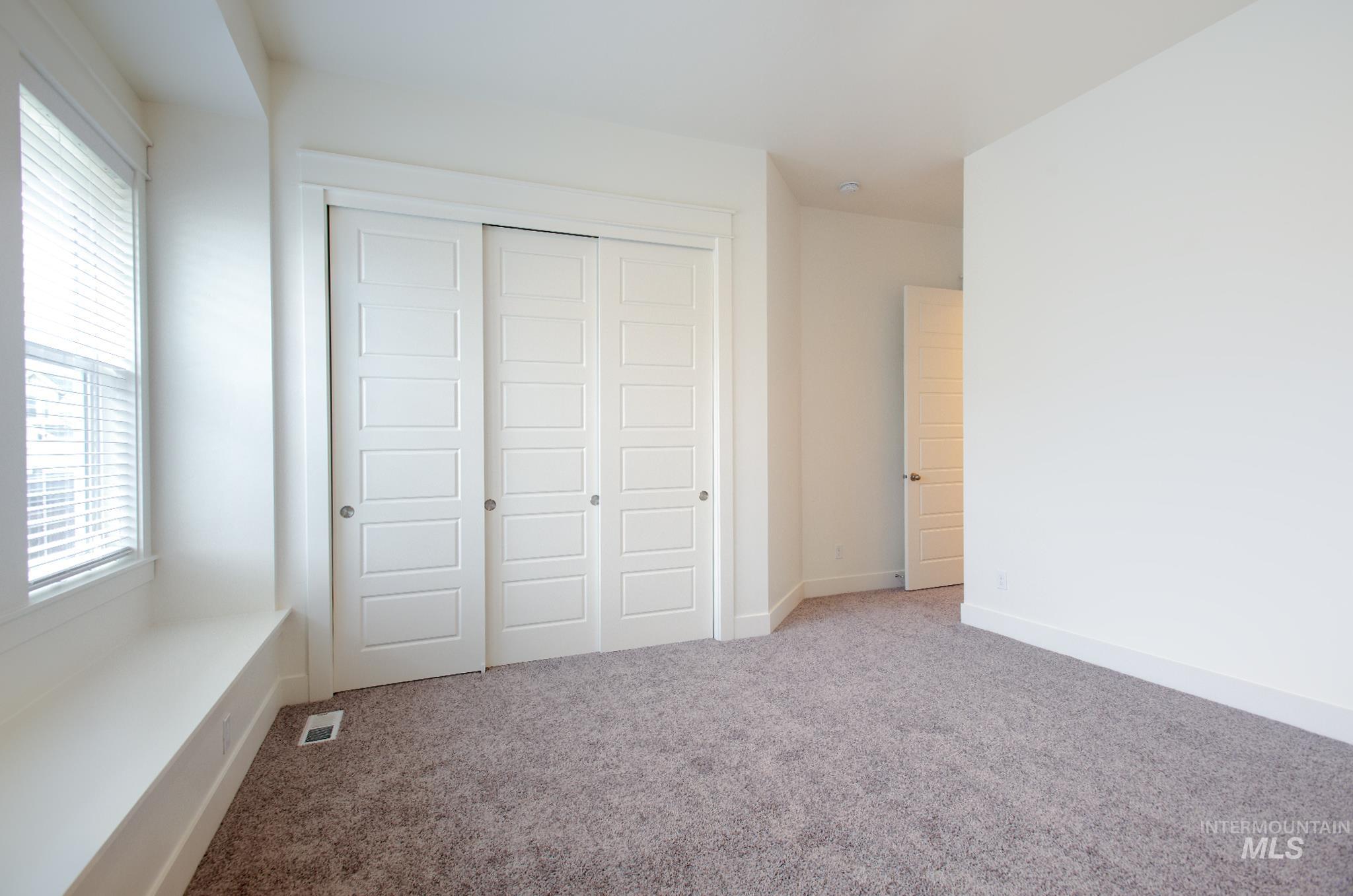 Unfurnished bedroom featuring a closet and carpet