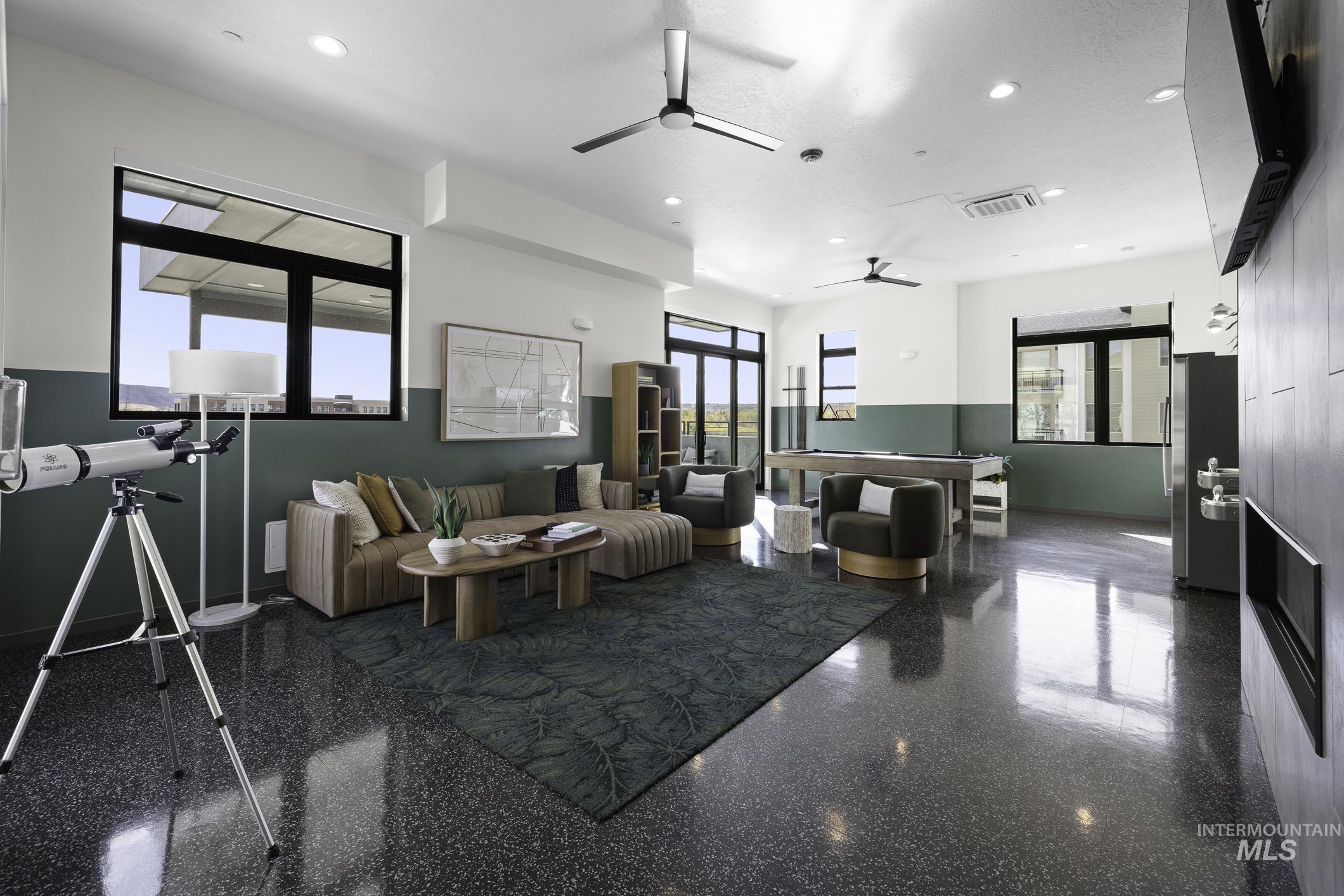 Living room with recessed lighting, ceiling fan, and granite tiled floors