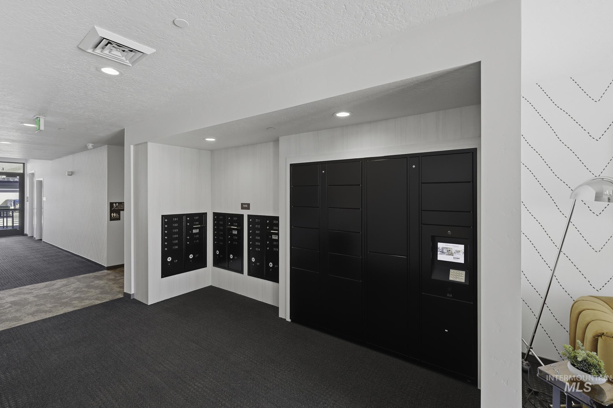 View of home's community with mail area and a textured ceiling