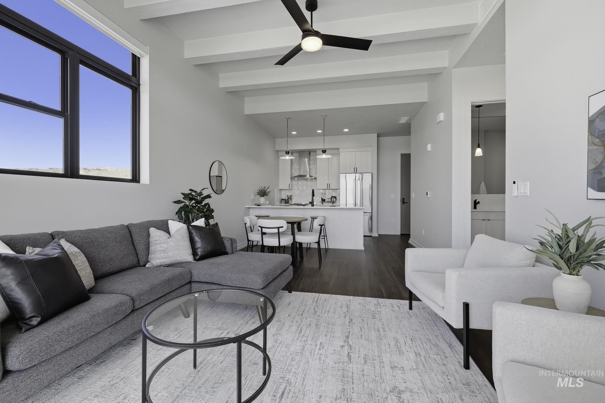 Living room with beamed ceiling, dark wood-type flooring, a ceiling fan, and recessed lighting