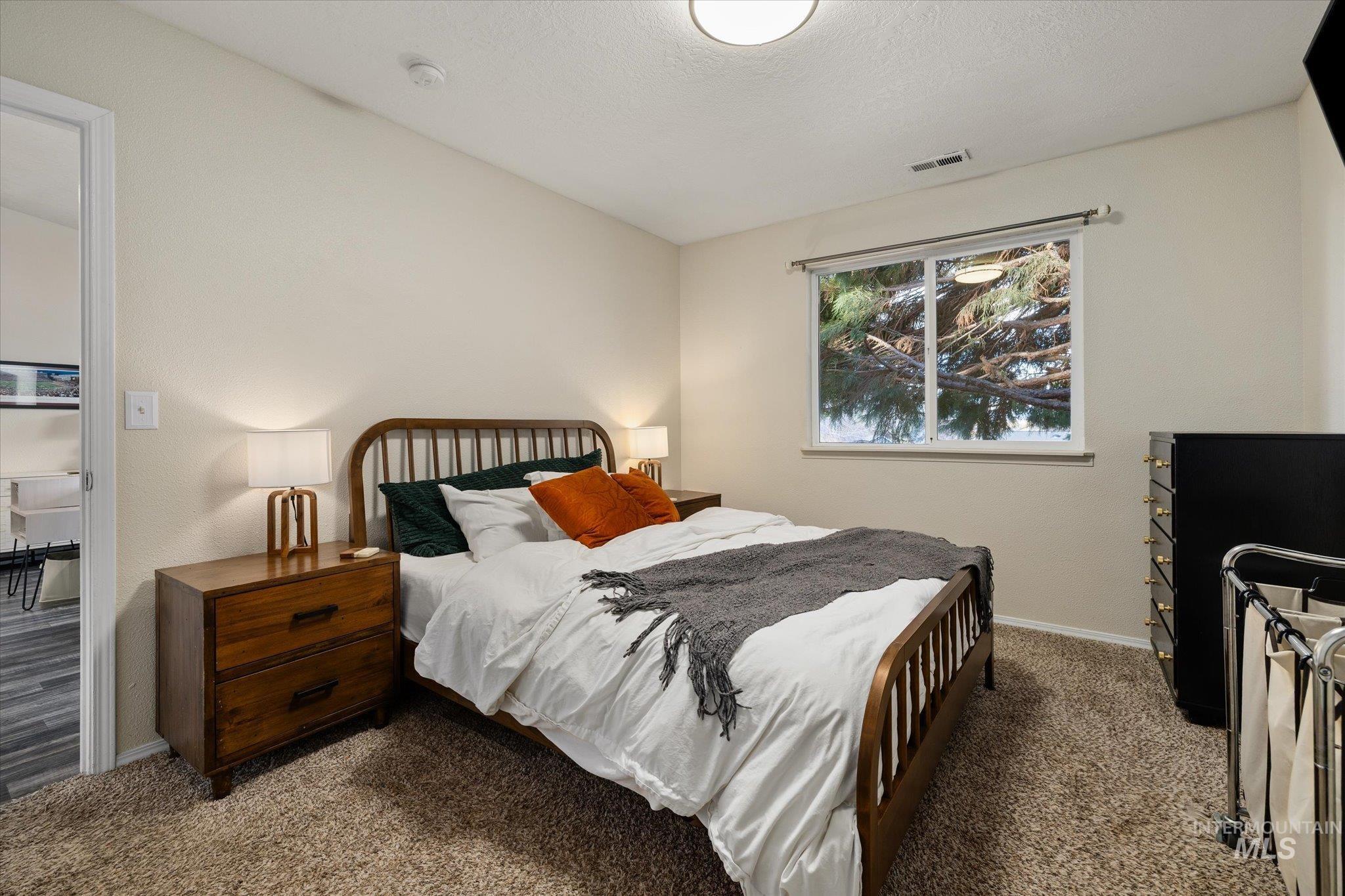 Bedroom featuring carpet flooring and a textured ceiling