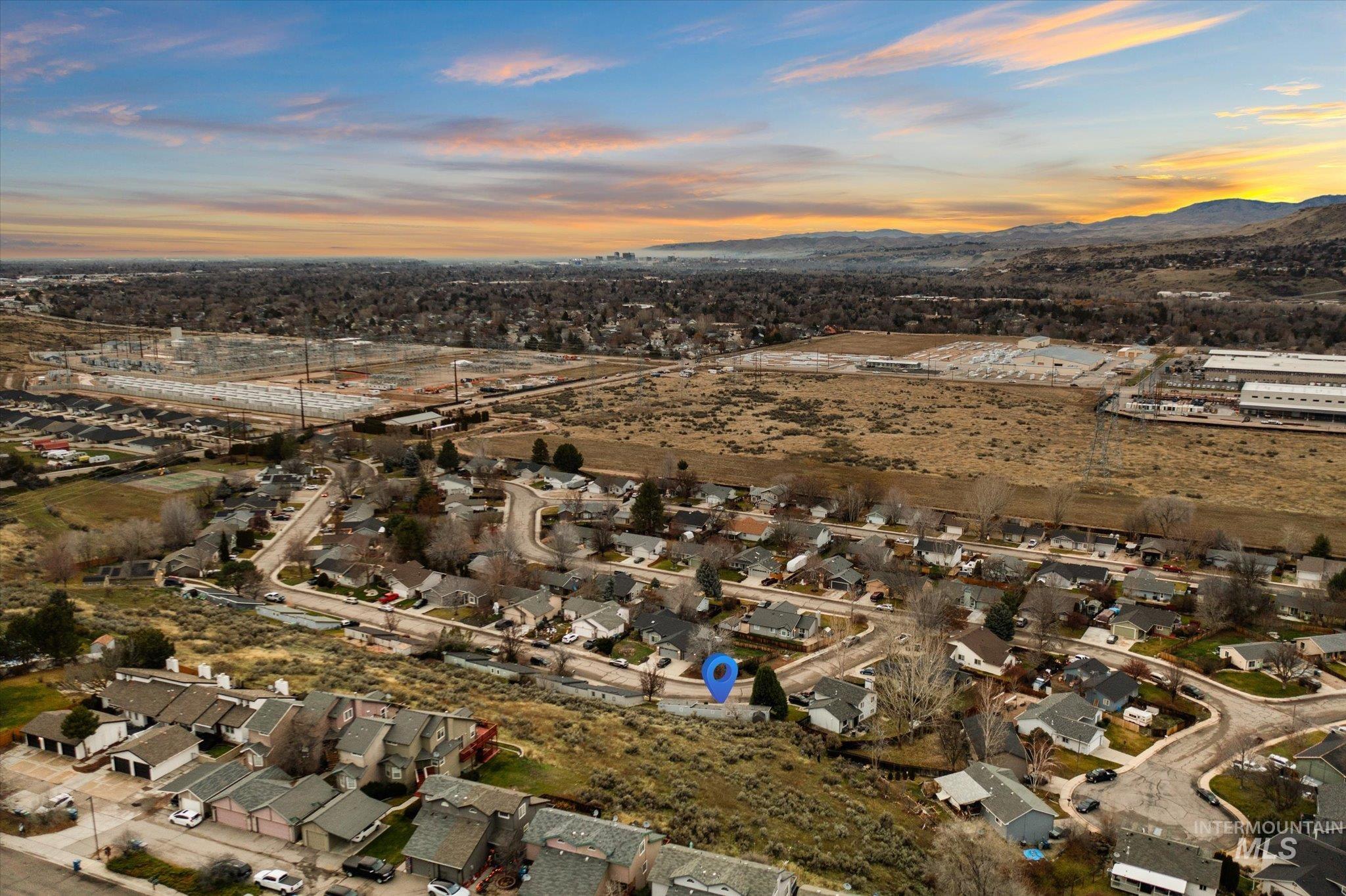 Aerial overview of property's location featuring nearby suburban area