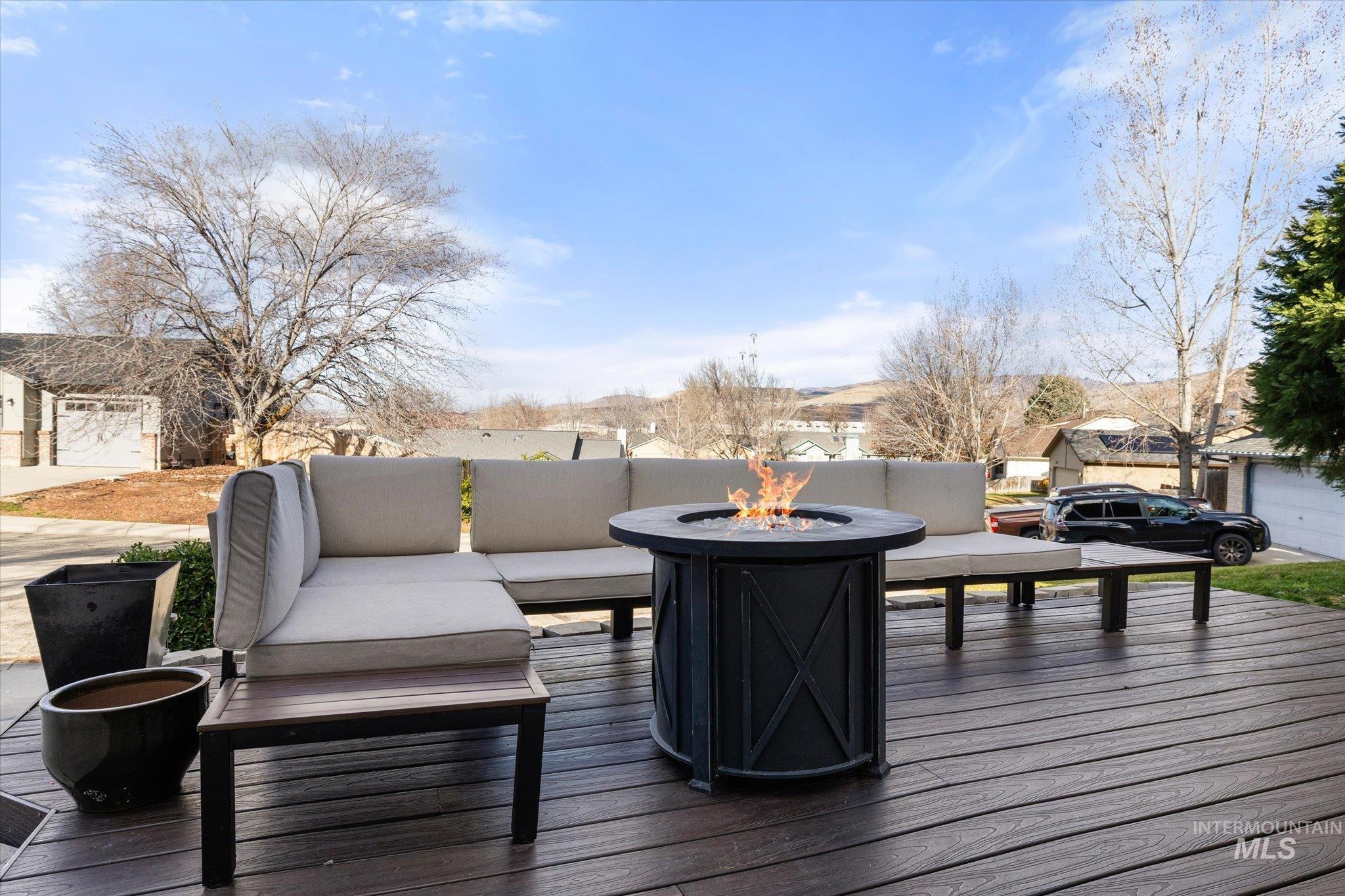 Wooden terrace featuring an outdoor living space with a fire pit