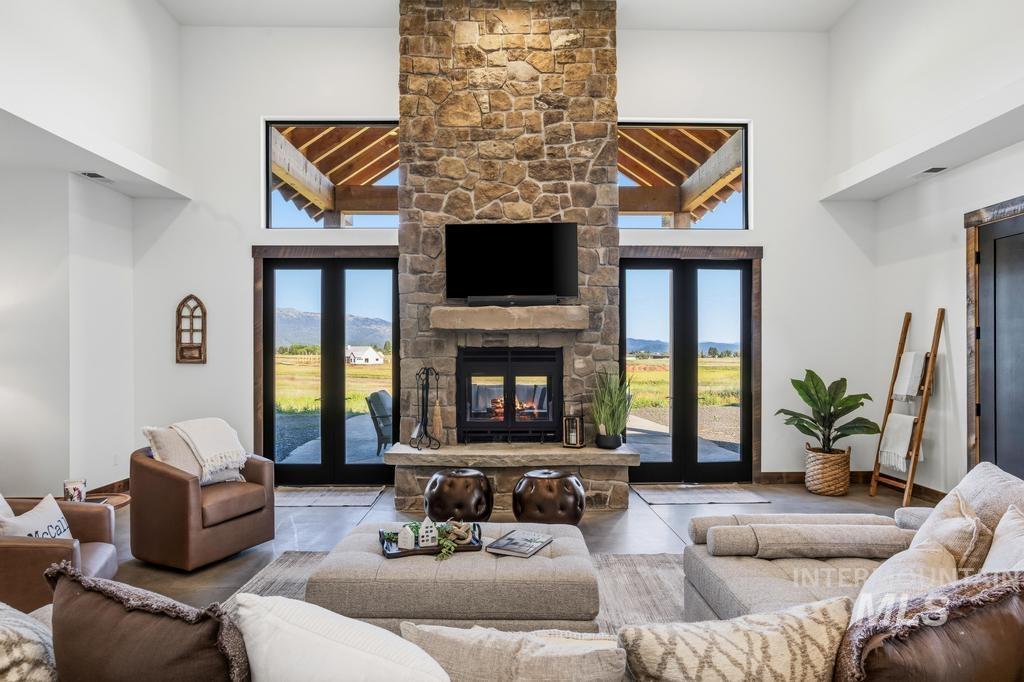 Vaulted ceilings with a prominent stone-clad fireplace and hearth