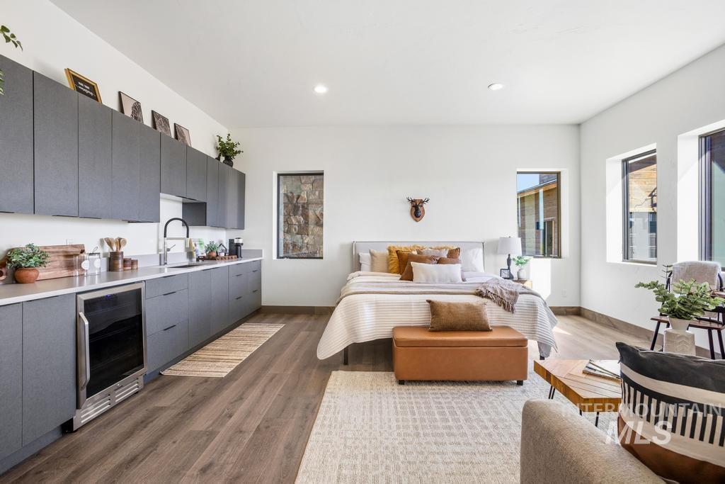 Open-concept living space featuring wood-finish flooring and multiple windows