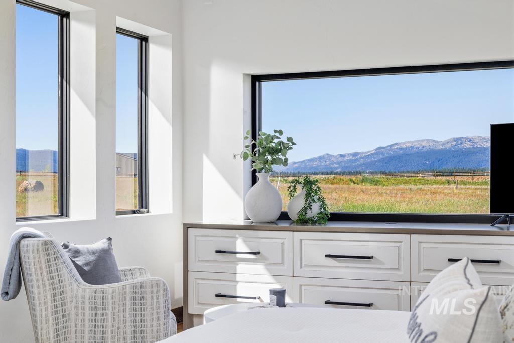Expansive picture window showcasing mountain and field scenery