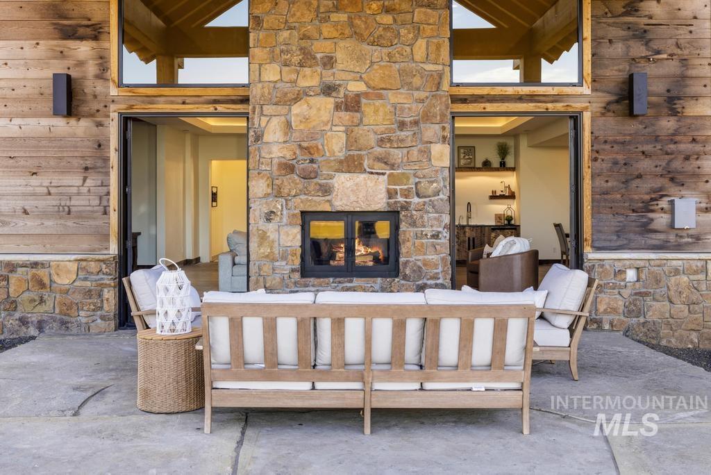 Stone and wood exterior featuring a built-in outdoor fireplace