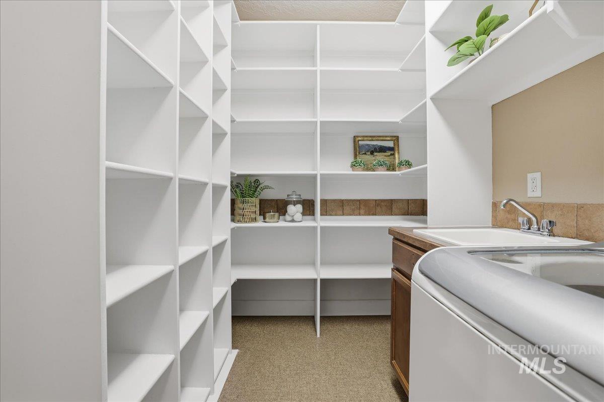 Pantry with washer / dryer and a sink