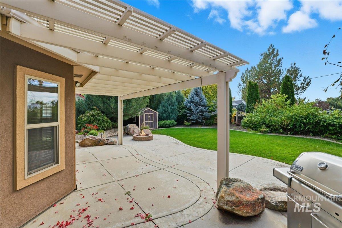 View of patio featuring a pergola, area for grilling, and a storage shed