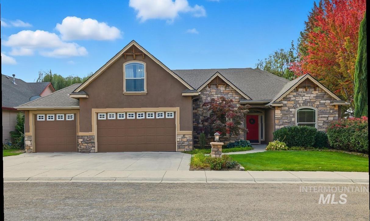 Craftsman-style home featuring stone siding, a front lawn, driveway, stucco siding, and a shingled roof