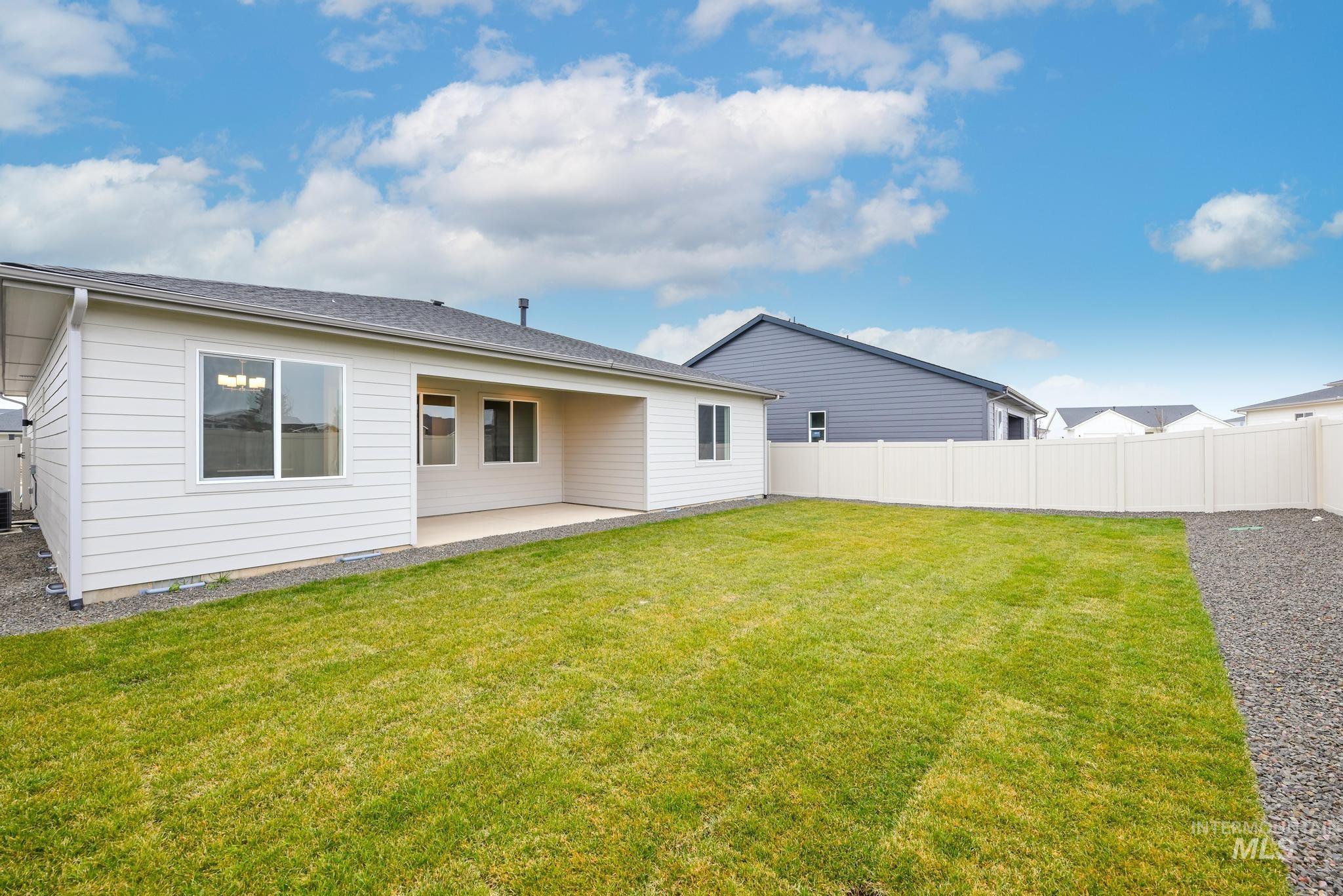 Rear view of property with a patio area and a fenced backyard
