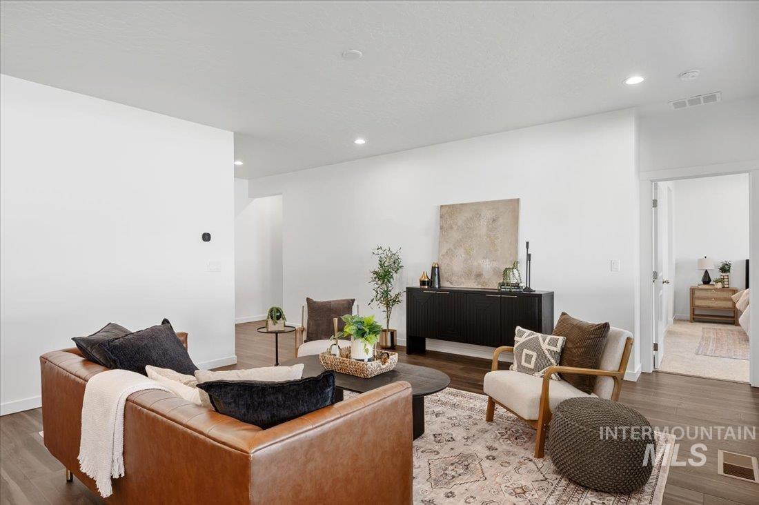 Living area with wood finished floors and recessed lighting