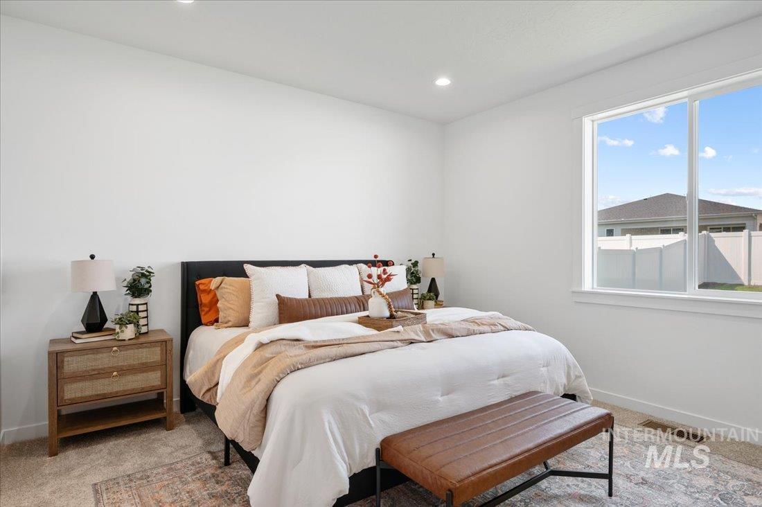 Bedroom featuring light colored carpet and recessed lighting