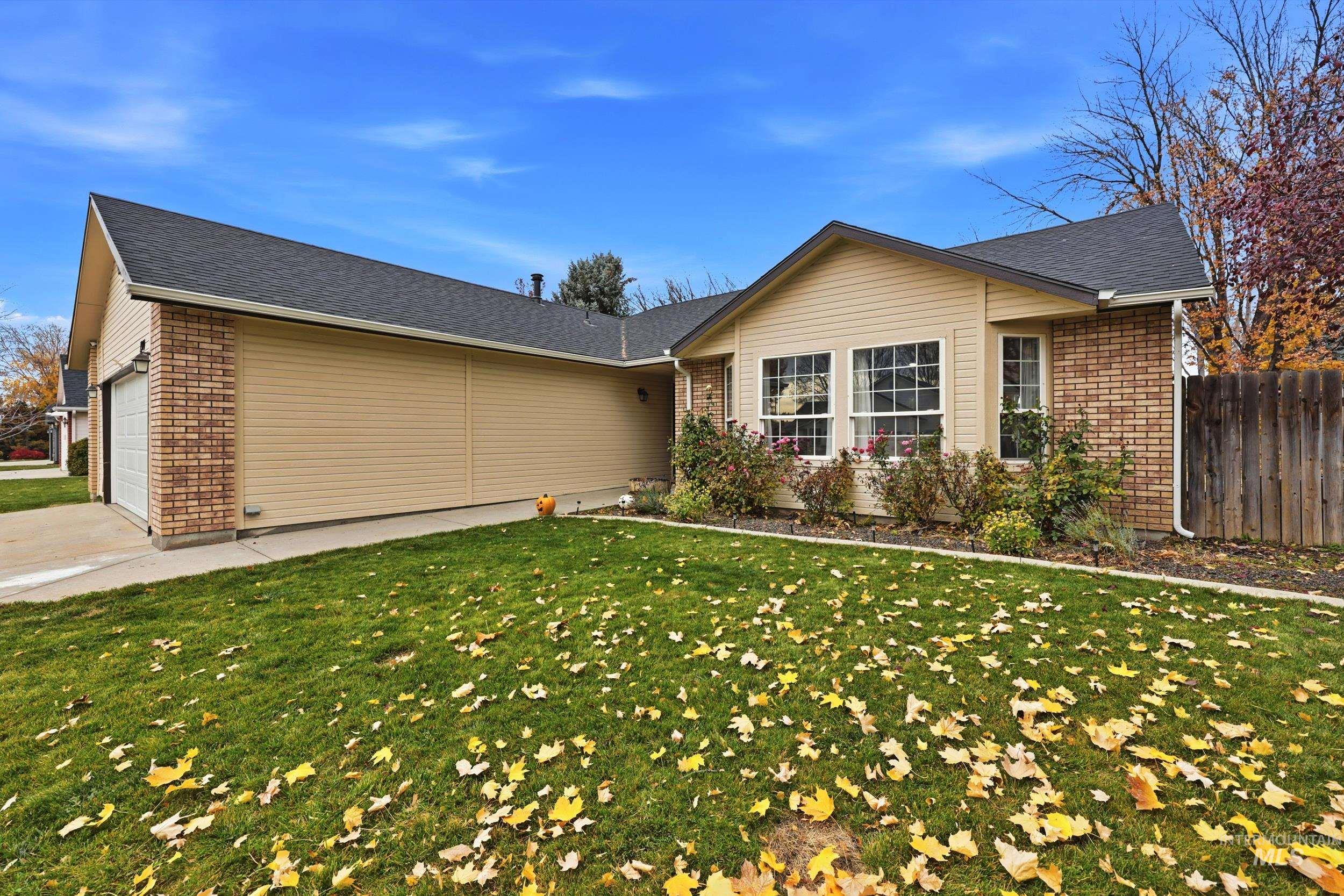 Single story home featuring brick siding, an attached garage, concrete driveway, and a shingled roof