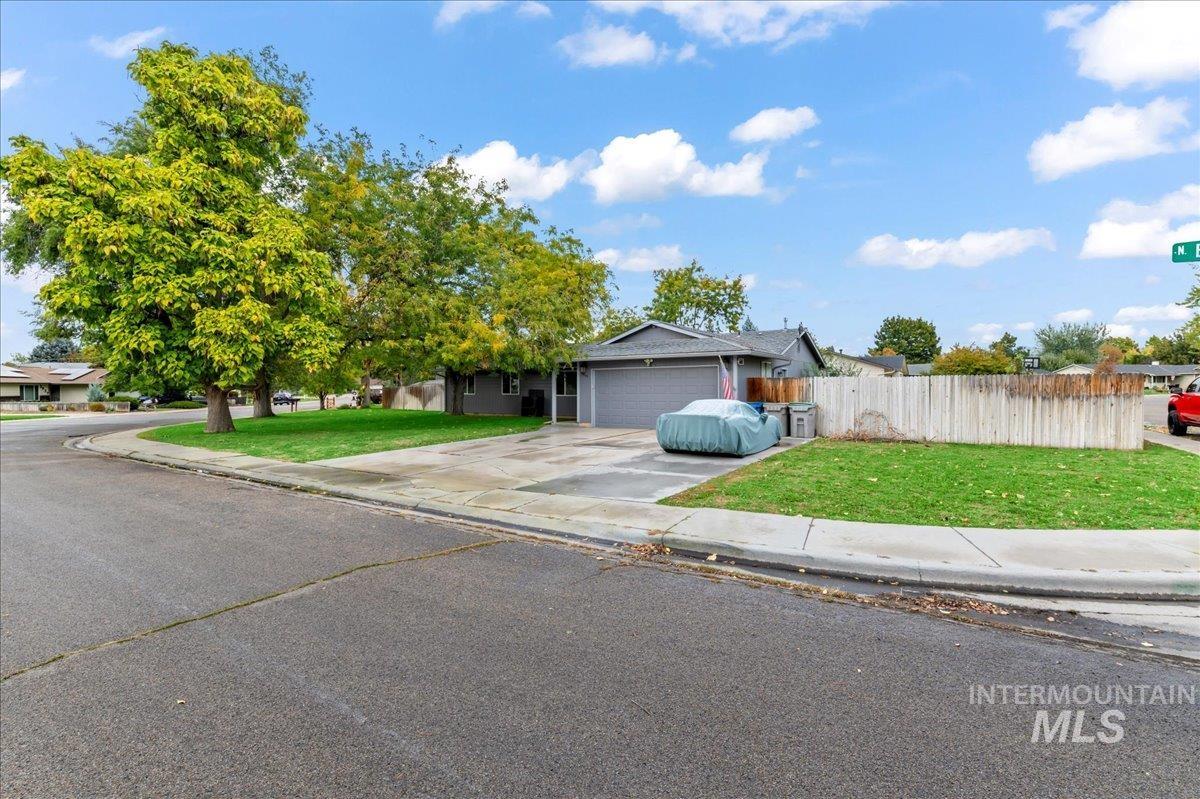View of front facade featuring driveway and a garage
