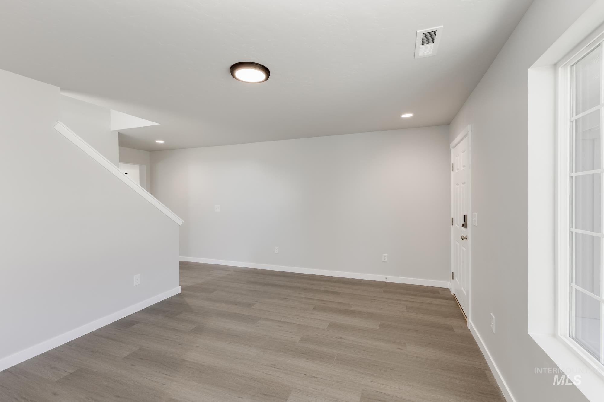 Unfurnished room featuring wood finished floors and recessed lighting