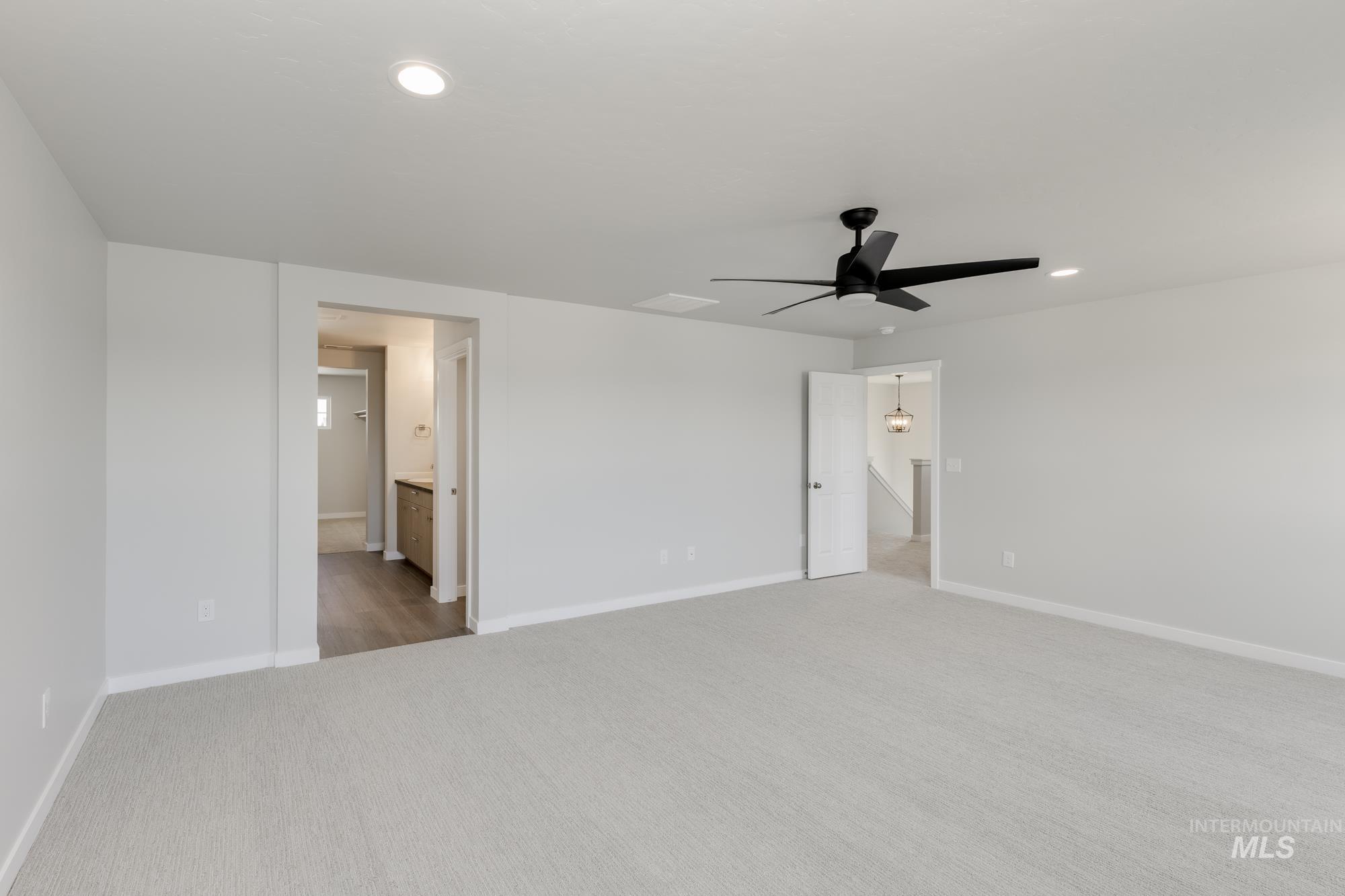 Unfurnished bedroom with carpet flooring, recessed lighting, ensuite bathroom, and a ceiling fan
