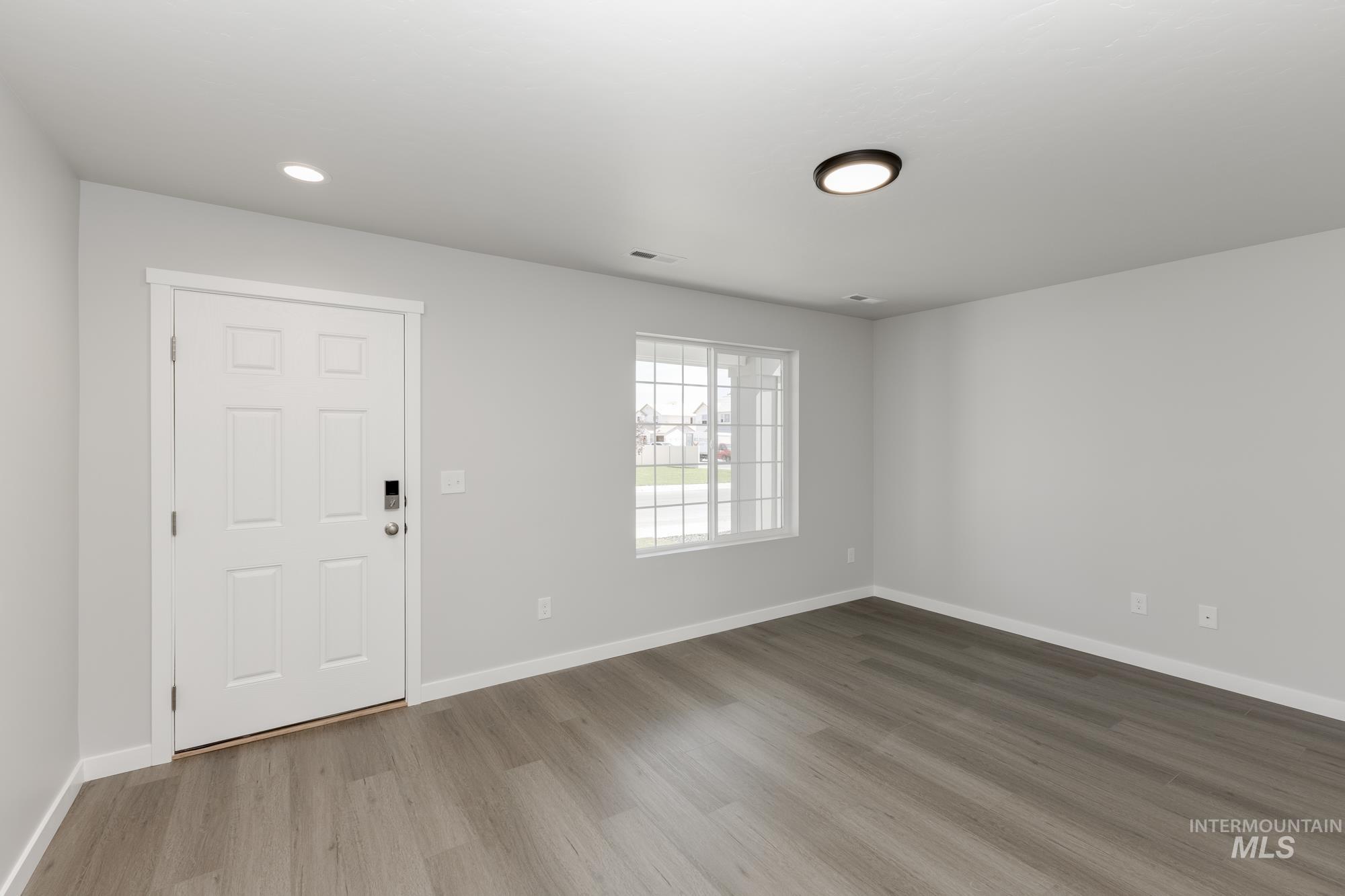 Foyer featuring wood finished floors and recessed lighting