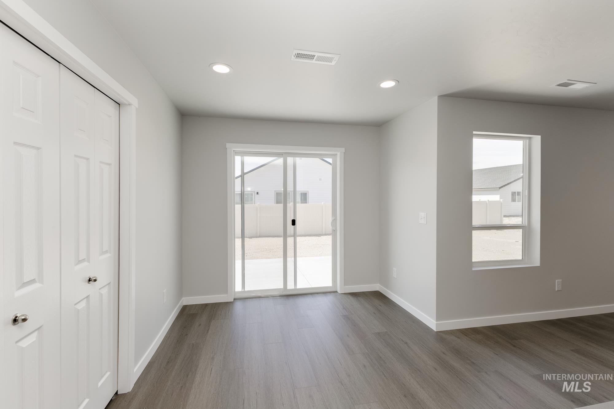 Interior space featuring dark wood finished floors and recessed lighting