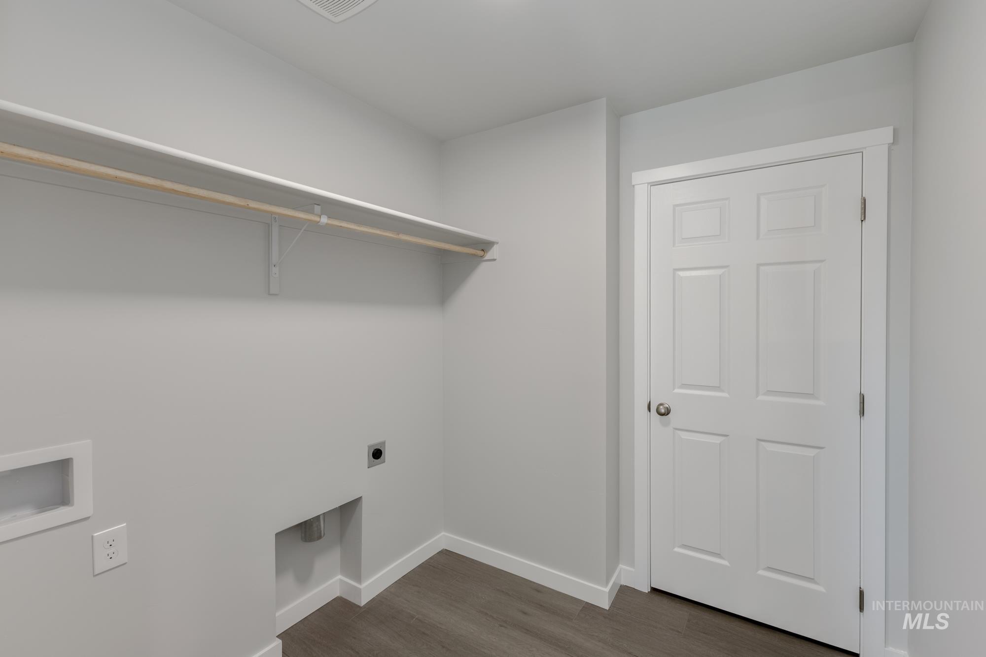 Washroom featuring hookup for an electric dryer, dark wood-style flooring, and washer hookup