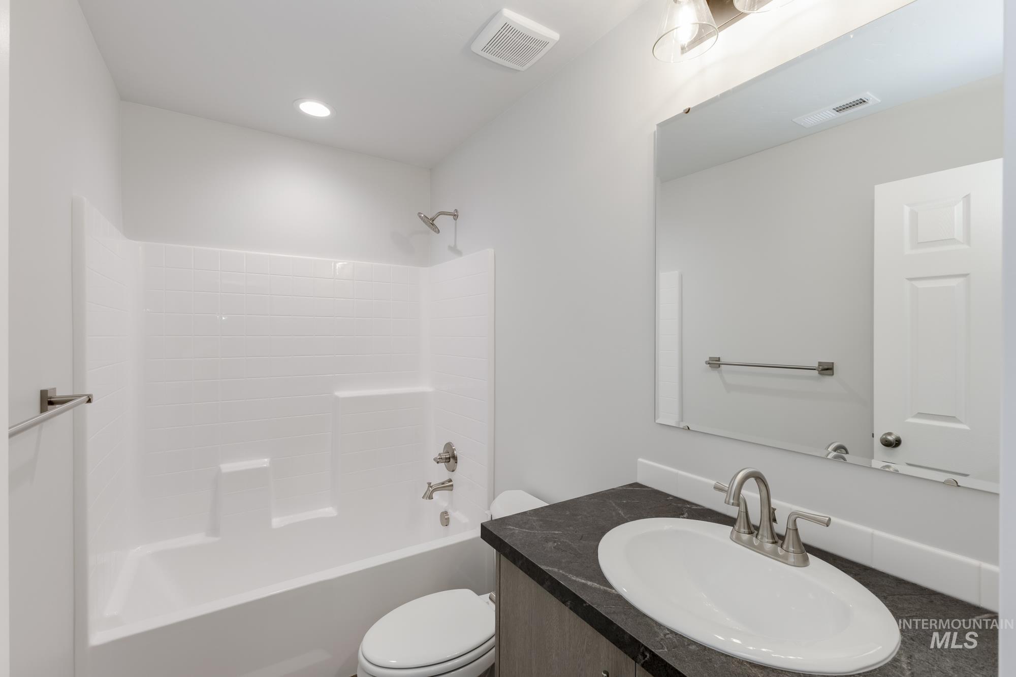 Bathroom featuring vanity and shower / tub combination