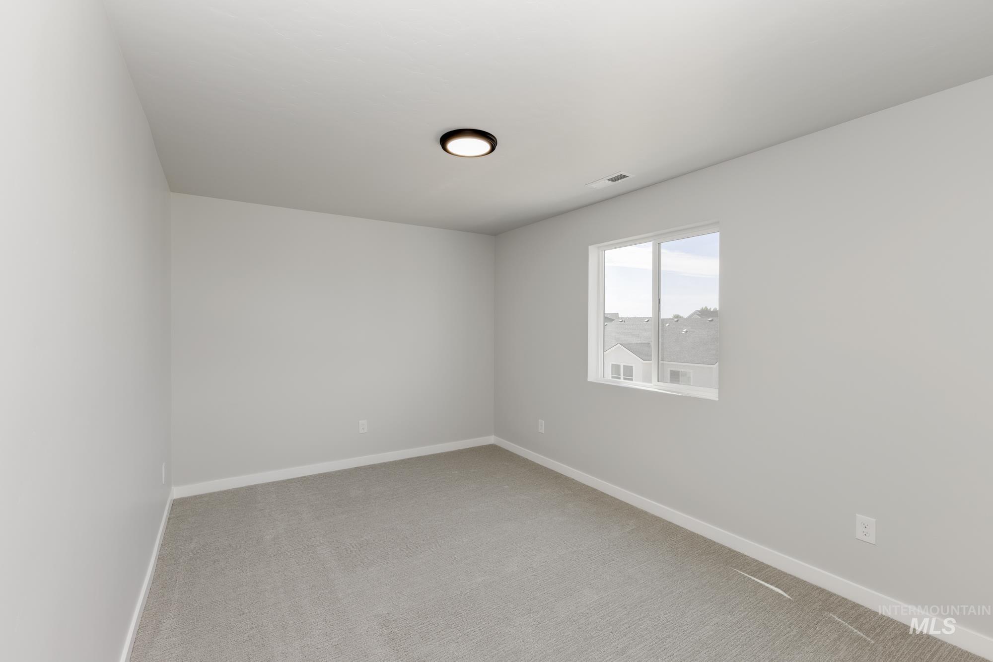 Unfurnished room featuring baseboards and light colored carpet