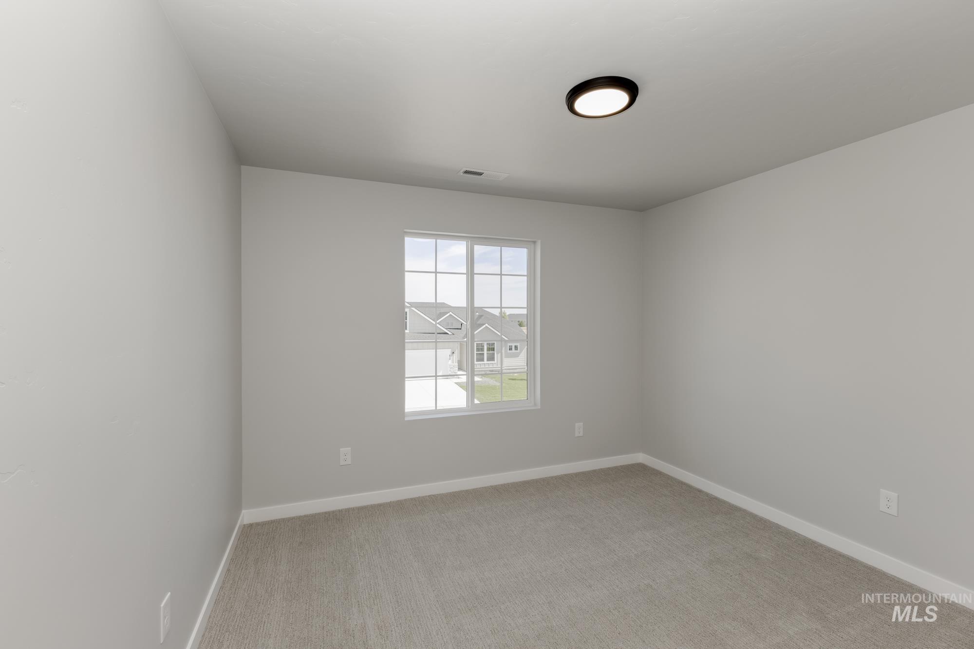 Unfurnished room featuring carpet floors and baseboards