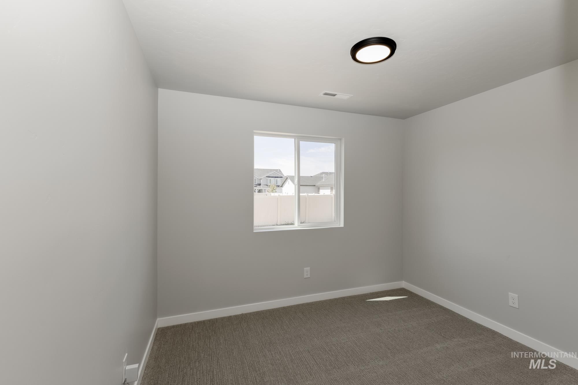 Empty room with dark carpet