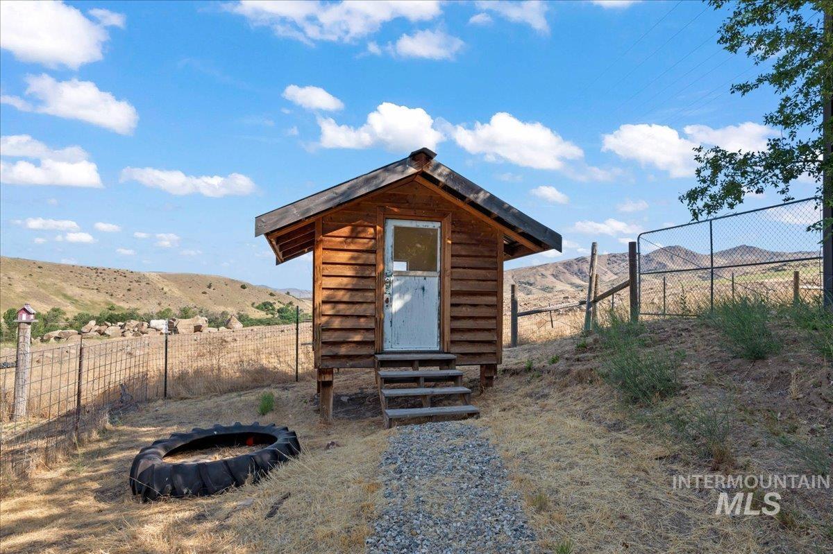View of kids playhouse with a mountain view and entry steps