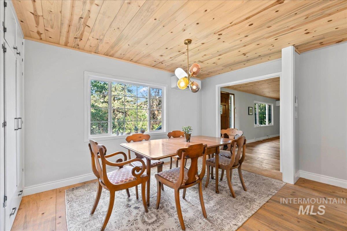 Dining area with wooden ceiling and hardwood floors