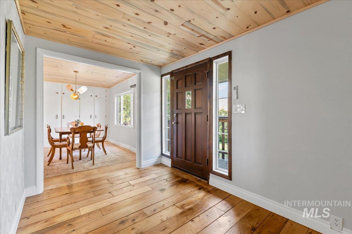 Foyer with wooden ceiling and light wood-style flooring