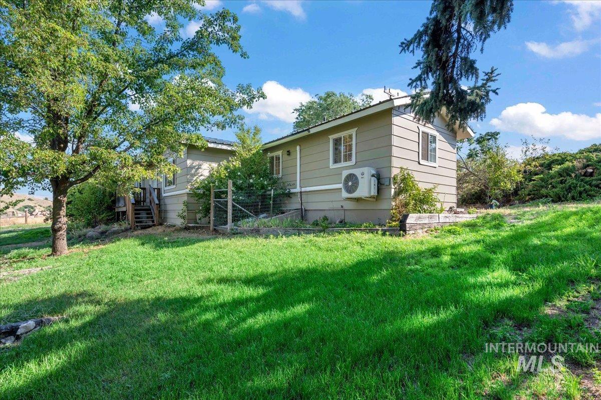 View of home's exterior featuring a lawn front stairs