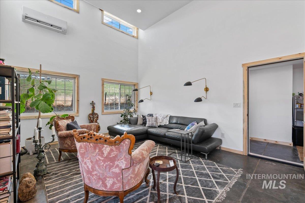 ADU living room with a wall mounted heat/AC mini split and vaulted ceiling