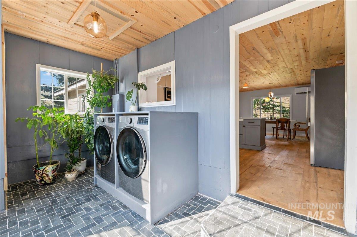 Laundry area with wood ceiling and washing machine and dryer.  This is also the mudroom