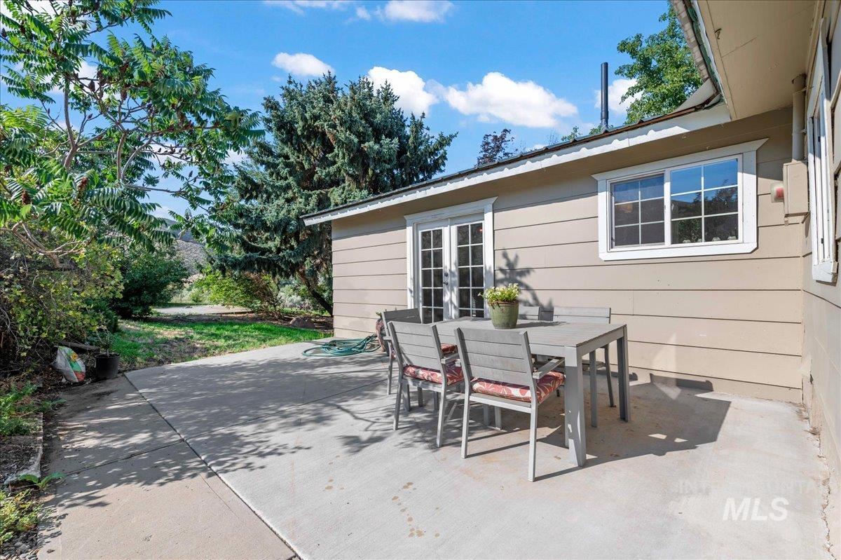 View of patio / terrace featuring outdoor dining space and french doors into the master bedroom