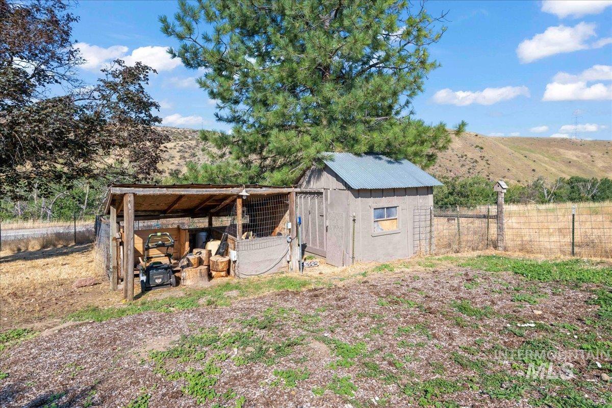 View of poultry coop and storage shed with a mountain view