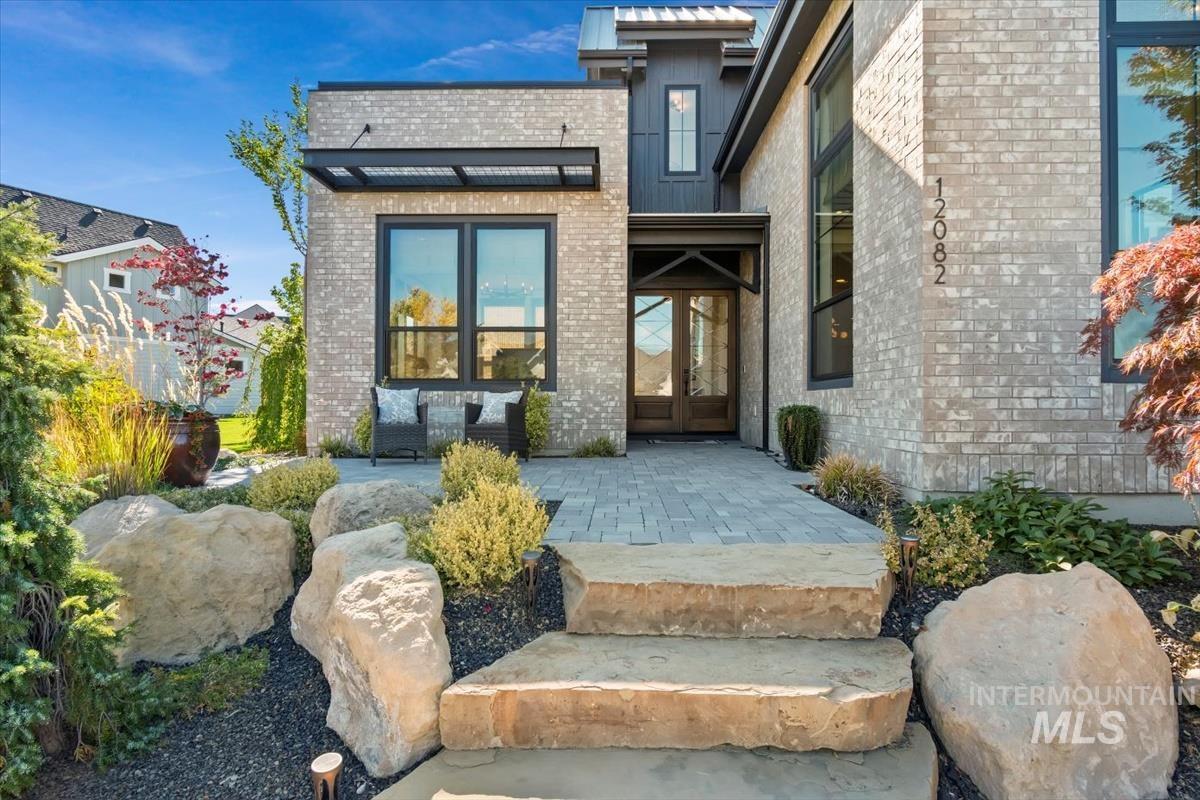Doorway to property with brick siding and french doors