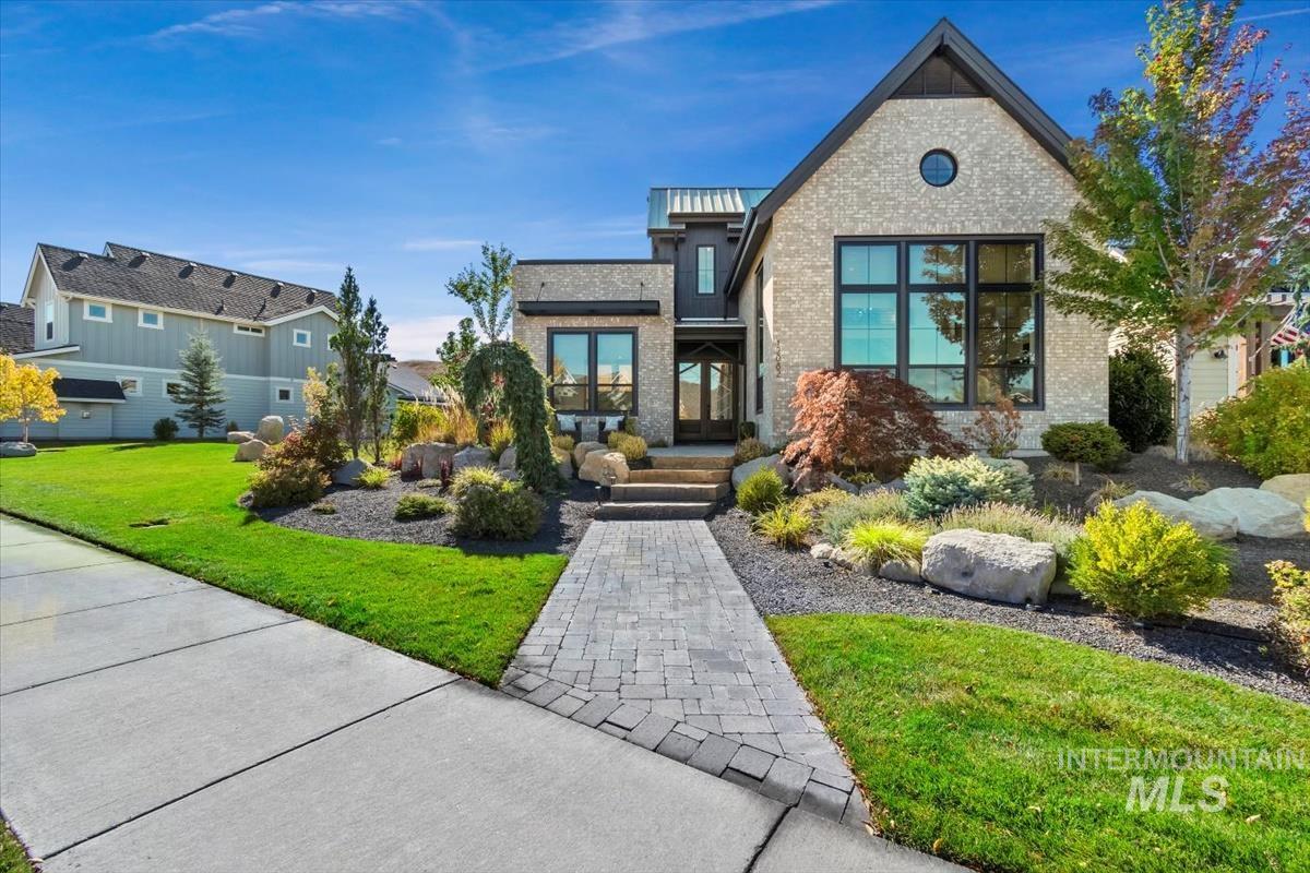 View of front facade featuring a front lawn and brick siding