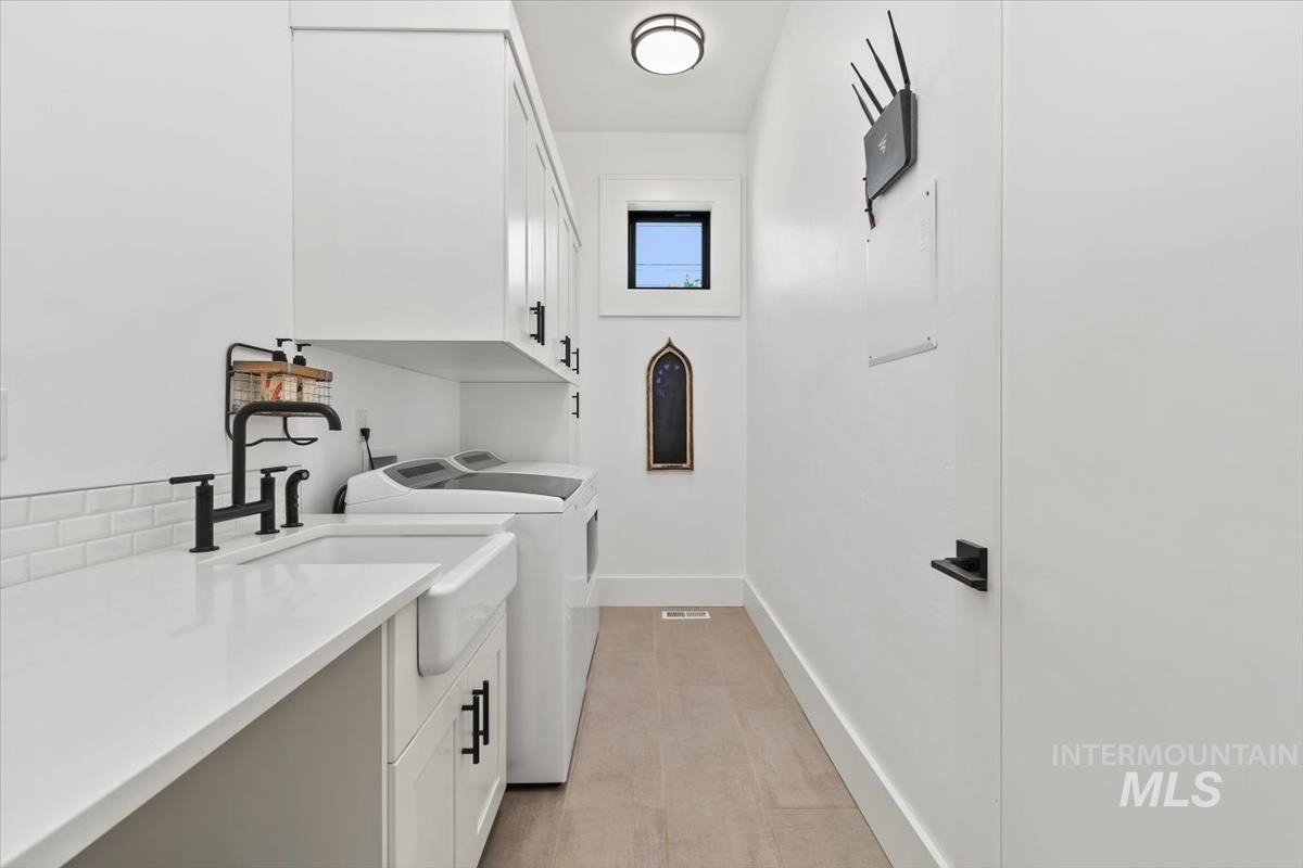 Washroom with cabinet space and independent washer and dryer