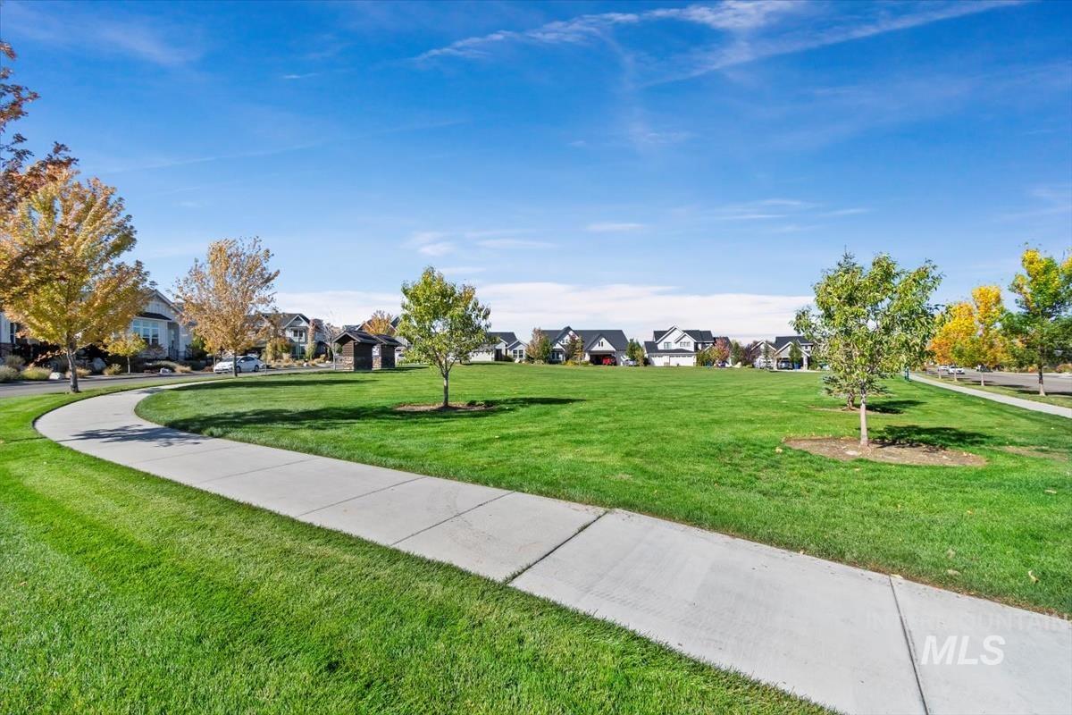 View of community featuring a yard and a residential view