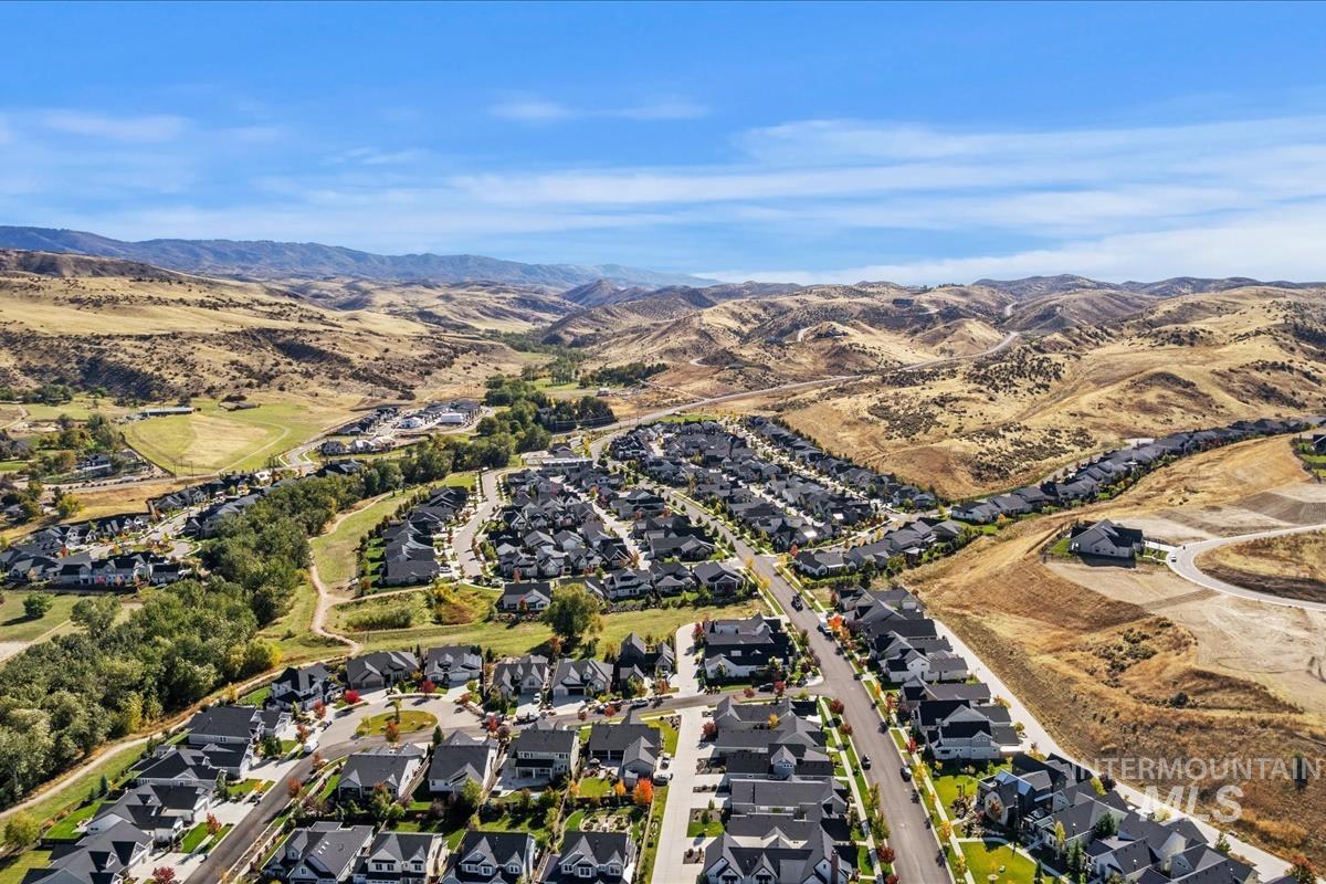 Aerial overview of property's location with nearby suburban area and mountains