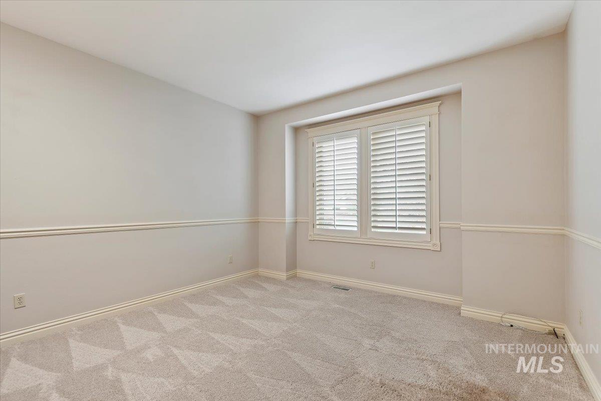 Unfurnished room with light carpet and baseboards
