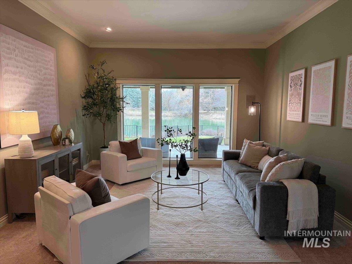 Living area featuring crown molding and baseboards