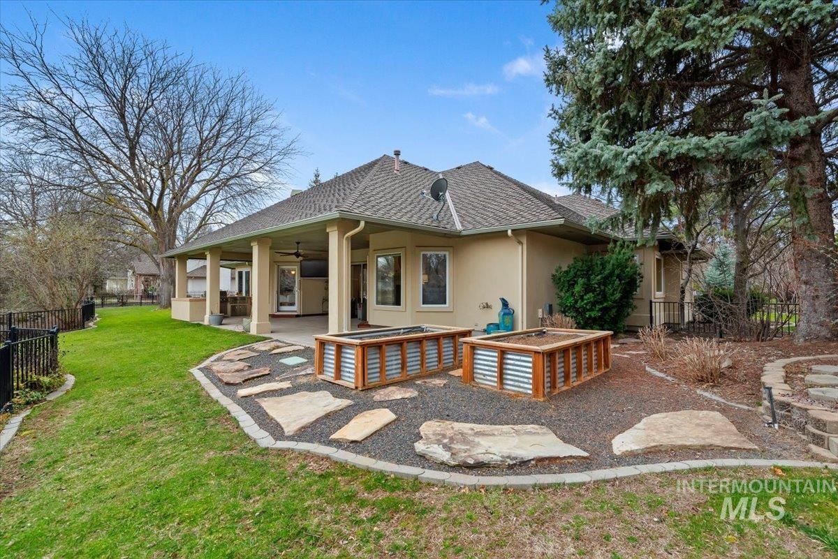 Back of house with a fenced backyard, a patio, stucco siding, and ceiling fan