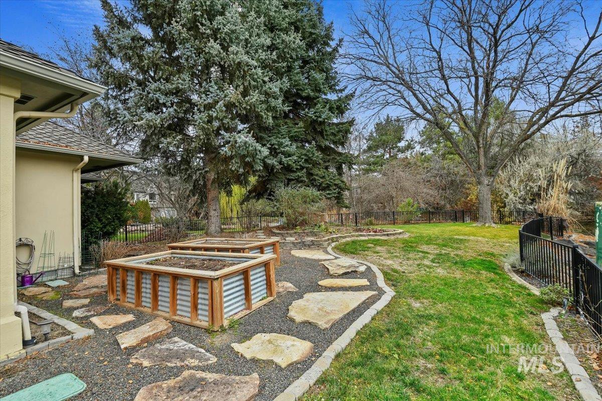 Fenced backyard featuring a patio and a garden