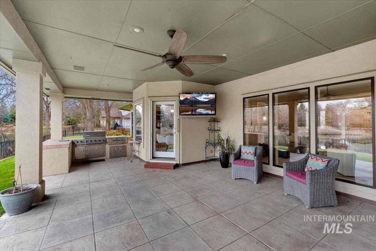 View of patio / terrace featuring a ceiling fan and exterior kitchen