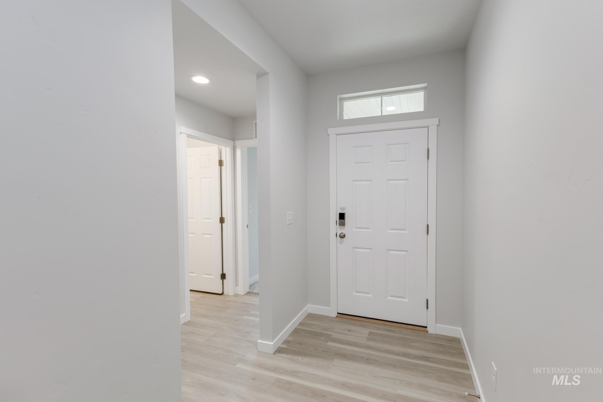 Foyer entrance featuring baseboards and light wood-style flooring
