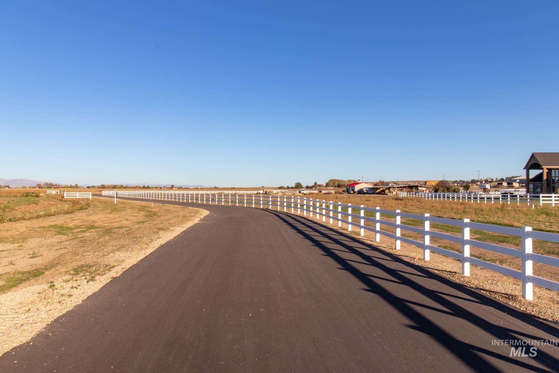 View of asphalt road featuring a rural view