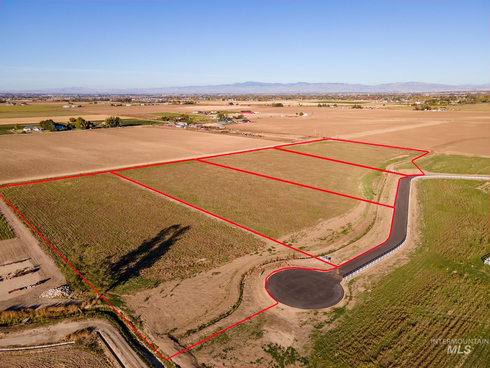 Overview of rural landscape with property parcel outlined and mountains